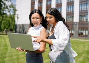 Women Looking at the Screen of a Laptop | FintechZoom
