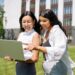 Women Looking at the Screen of a Laptop | FintechZoom
