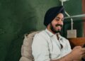 Happy Indian man with smartphone | IBOMMA TV